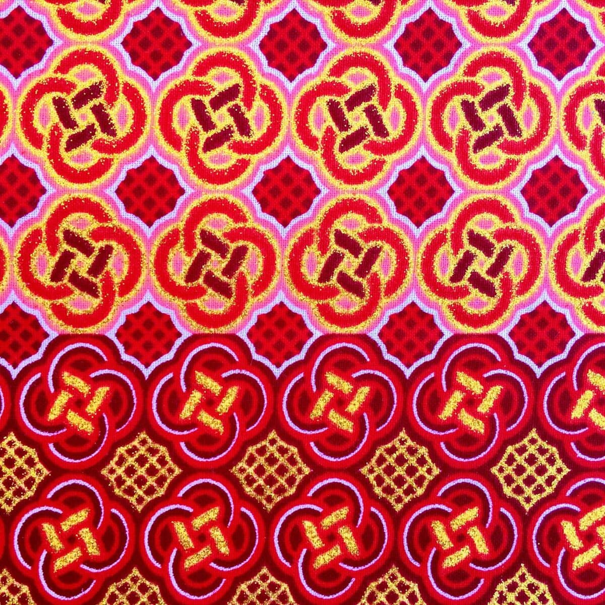 Tissu Wax pailleté rouge orangé imprimé Celte détail bordure